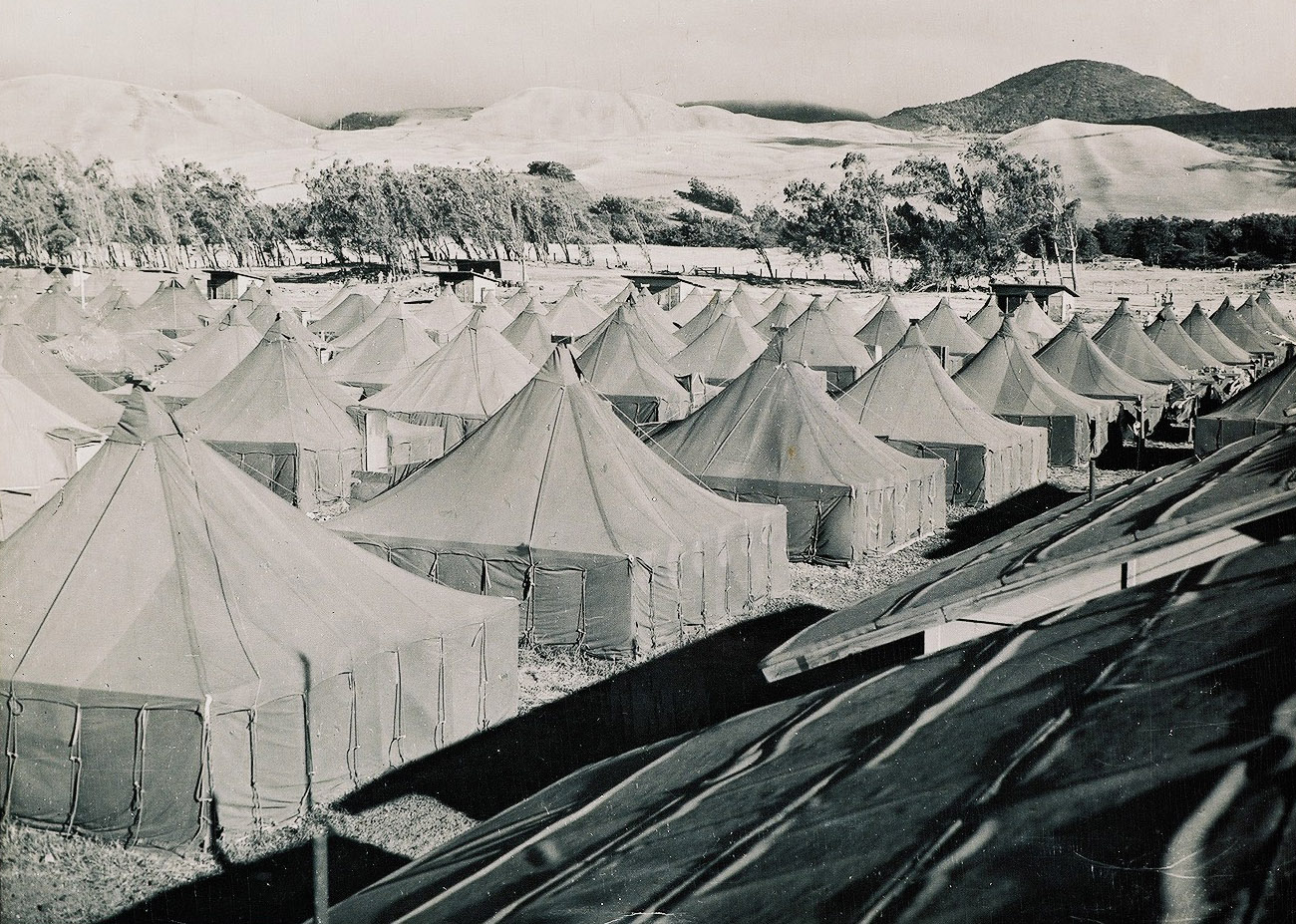 A photo showing tents in Camp Tarawa with the Kohala Mountains in the background.